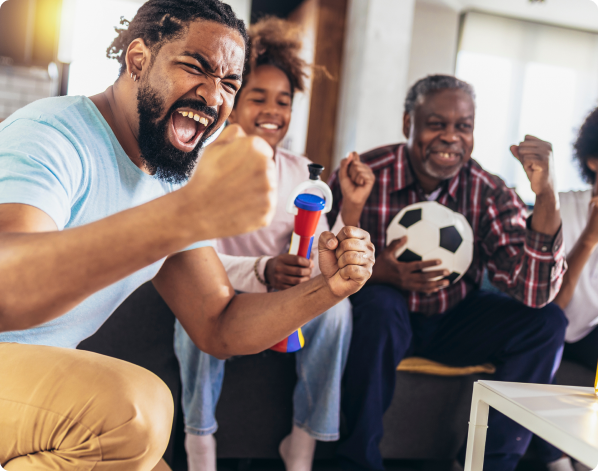 group_of_friends_rooting_together_while_watching_a_football_match